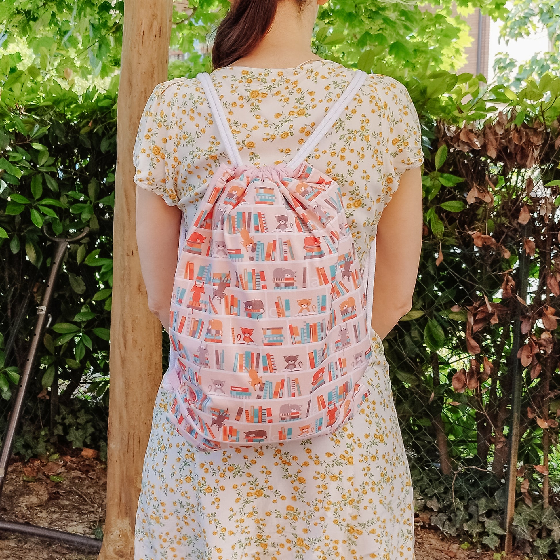 Sacca zaino con coulisse fantasy libri gatti in libreria - indossata